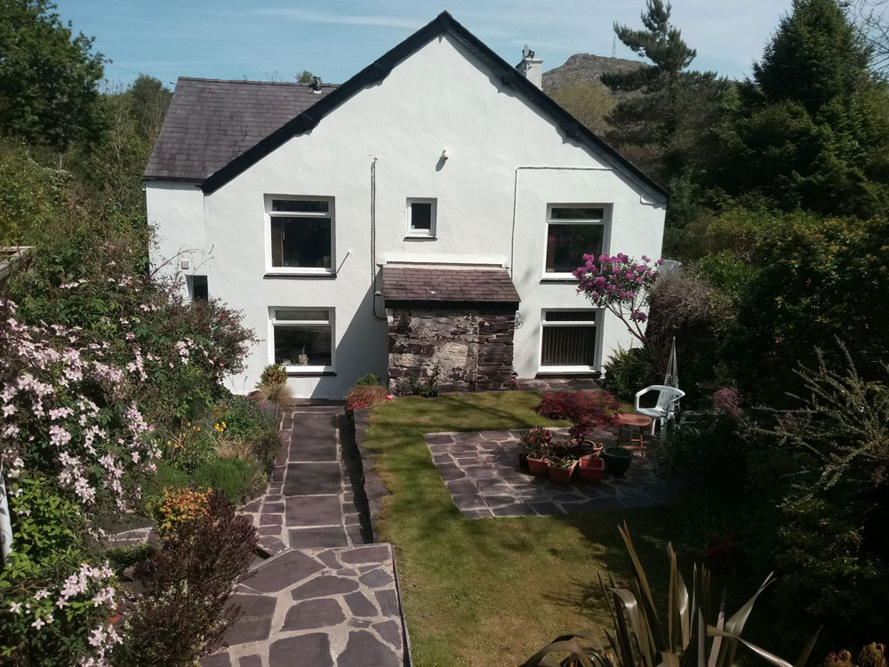 A view of the back of the house and the garden at Glyn Peris Guest House