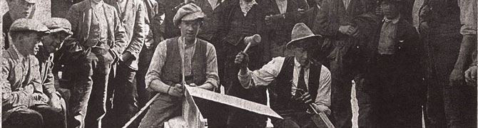 Old black and white photo of men splitting slate at Dinorwig Quarry