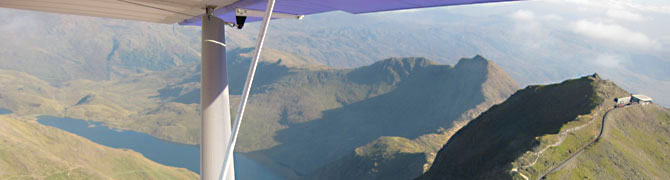 An aerial view of Snowdon, looking down on the Snowdon summit, Llanberis Path and Snowdon Mountain Railway.